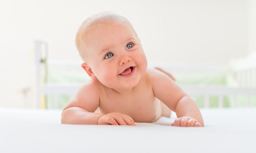 image of a baby laying down a bed