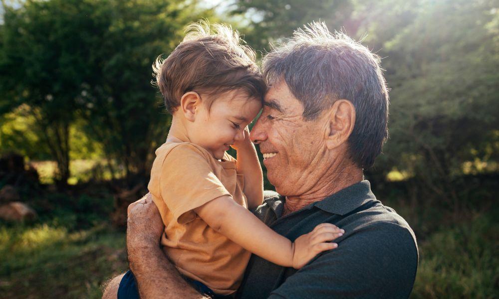 senior man cuddling grandson