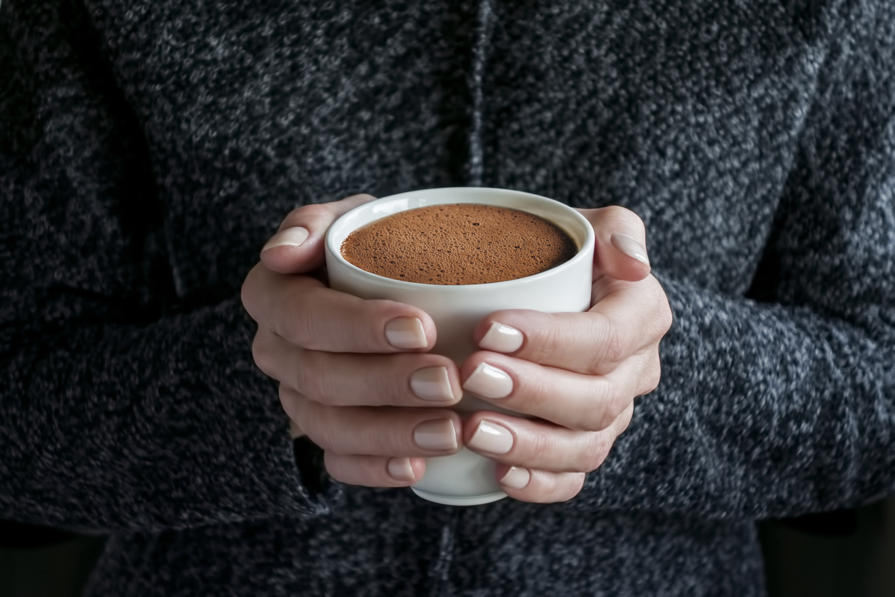 hands holding a cup of hot chocolate